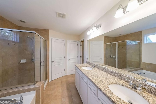 bathroom with tile patterned flooring, vanity, and independent shower and bath