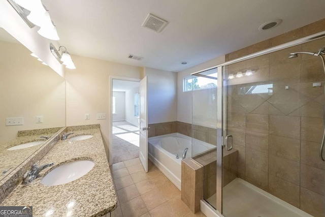 bathroom featuring tile patterned flooring, vanity, and separate shower and tub