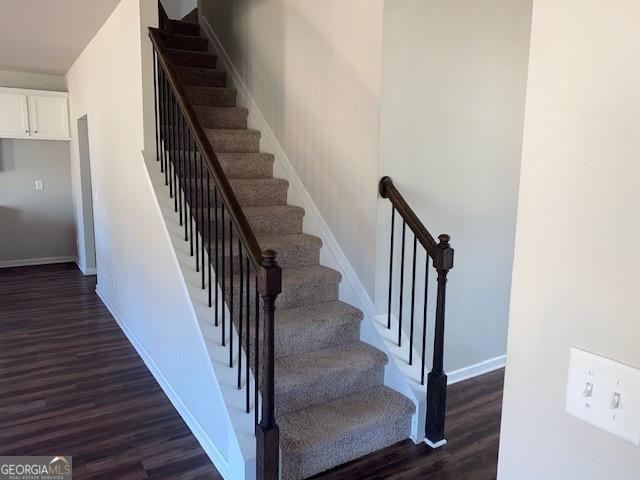 staircase with hardwood / wood-style flooring