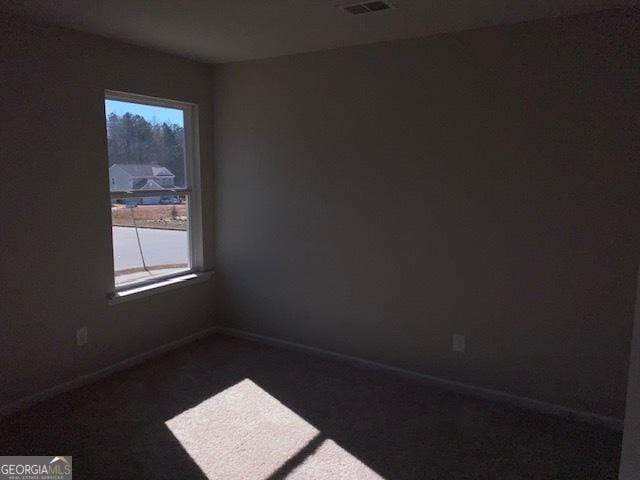 unfurnished room featuring plenty of natural light