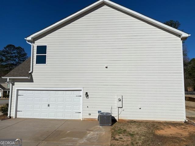 view of side of property featuring central AC unit