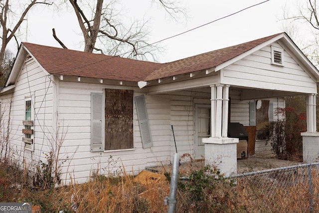 view of side of property with covered porch