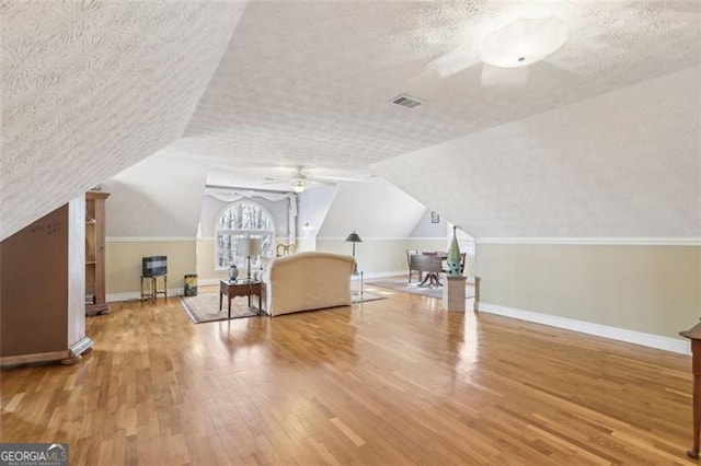 301 Benson Rd, Dallas, GA 30132 - additional living space with hardwood / wood-style floors, ceiling fan, a textured ceiling, and vaulted ceiling