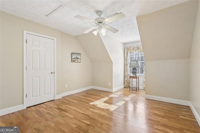 301 Benson Rd, Dallas, GA 30132 - bonus room featuring lofted ceiling, ceiling fan, light hardwood / wood-style floors, and a textured ceiling