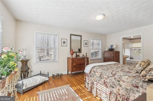 301 Benson Rd, Dallas, GA 30132 - bedroom featuring hardwood / wood-style floors, a textured ceiling, and multiple windows