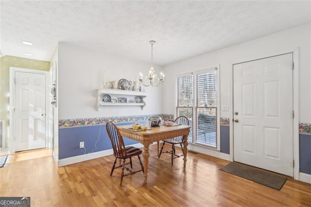 301 Benson Rd, Dallas, GA 30132 - dining area with a chandelier, a textured ceiling, and hardwood / wood-style flooring