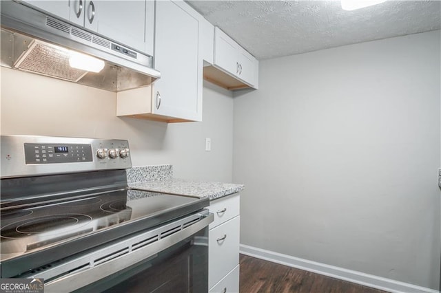 kitchen featuring white cabinetry, electric range, light stone countertops, dark wood-type flooring, and a textured ceiling