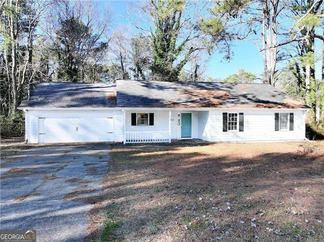 ranch-style house with covered porch and a garage