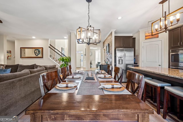 dining area featuring light hardwood / wood-style floors and ornamental molding