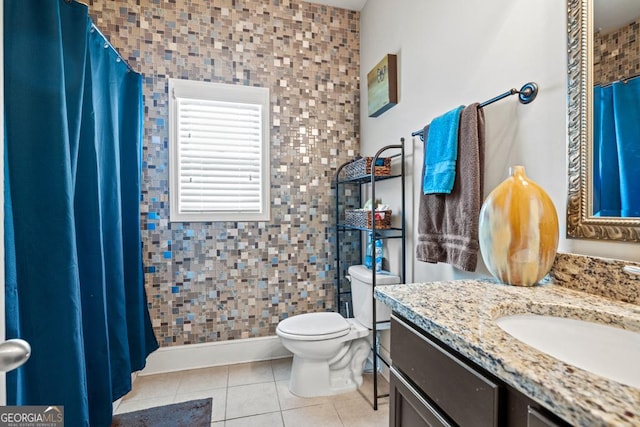 bathroom featuring tile patterned floors, vanity, and toilet