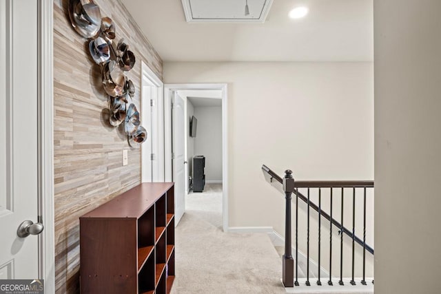 corridor with light carpet and wooden walls