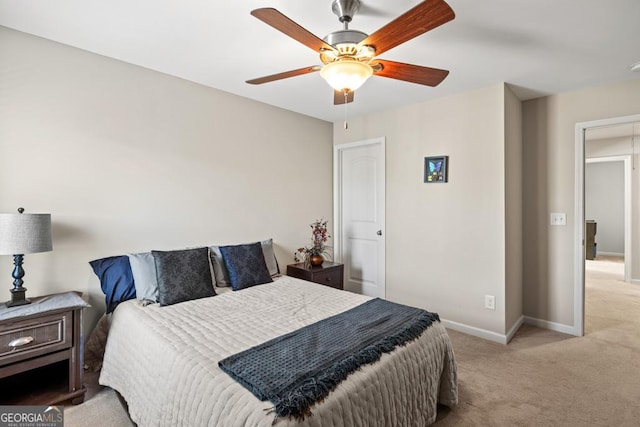 bedroom featuring ceiling fan and light carpet