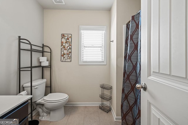 bathroom featuring tile patterned floors, vanity, and toilet