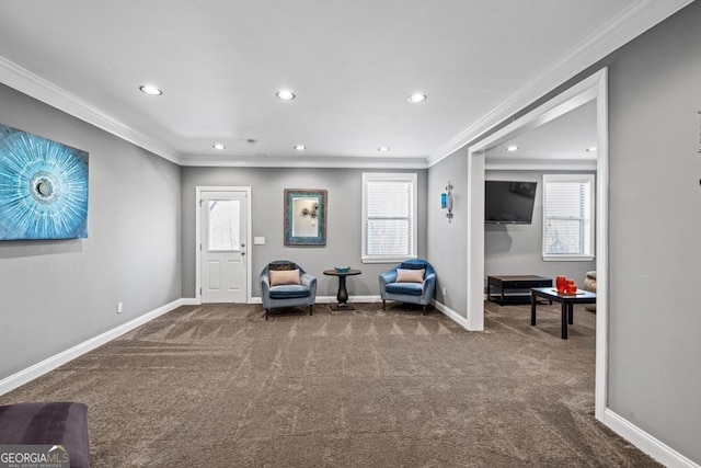 sitting room featuring carpet and crown molding