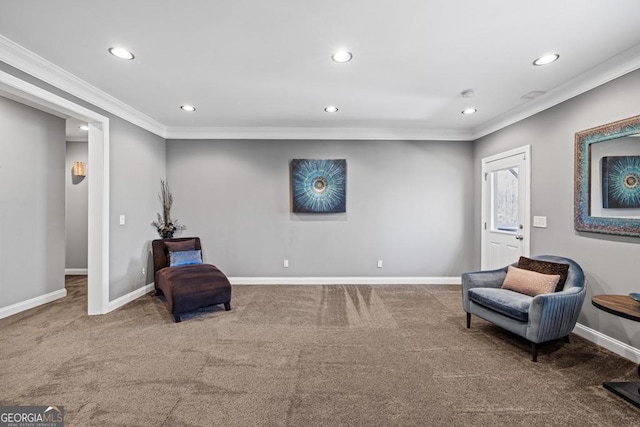 sitting room featuring carpet and crown molding