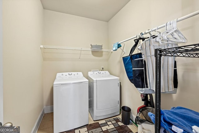 laundry area featuring separate washer and dryer and light tile patterned flooring