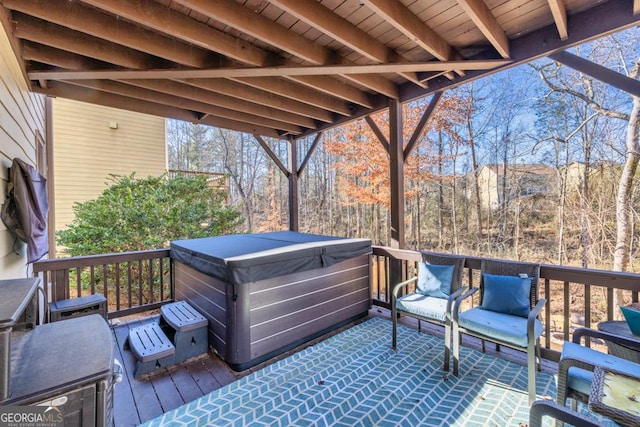 wooden deck featuring a hot tub