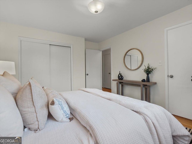 bedroom with hardwood / wood-style flooring and a closet