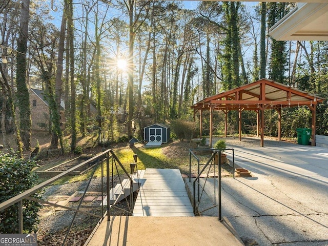 wooden deck featuring a gazebo and a storage unit