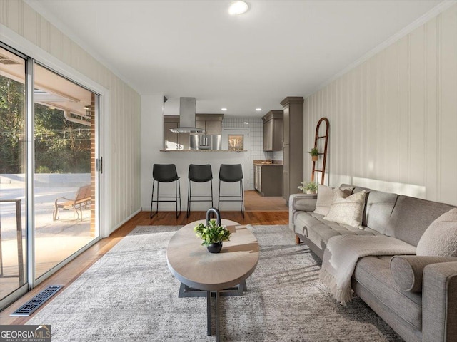 living room with hardwood / wood-style floors and ornamental molding