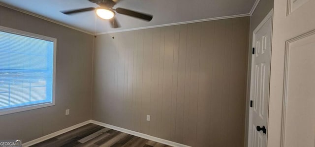 unfurnished room featuring ceiling fan, dark hardwood / wood-style floors, and ornamental molding