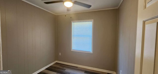 empty room featuring dark wood-type flooring, ceiling fan, and crown molding