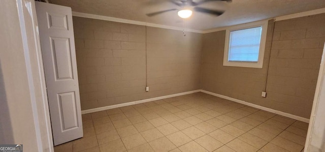 spare room featuring ceiling fan and crown molding