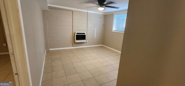 spare room featuring ceiling fan, light tile patterned floors, crown molding, and heating unit