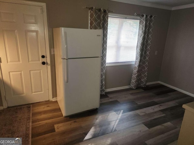 kitchen featuring white fridge, ornamental molding, and dark wood-type flooring