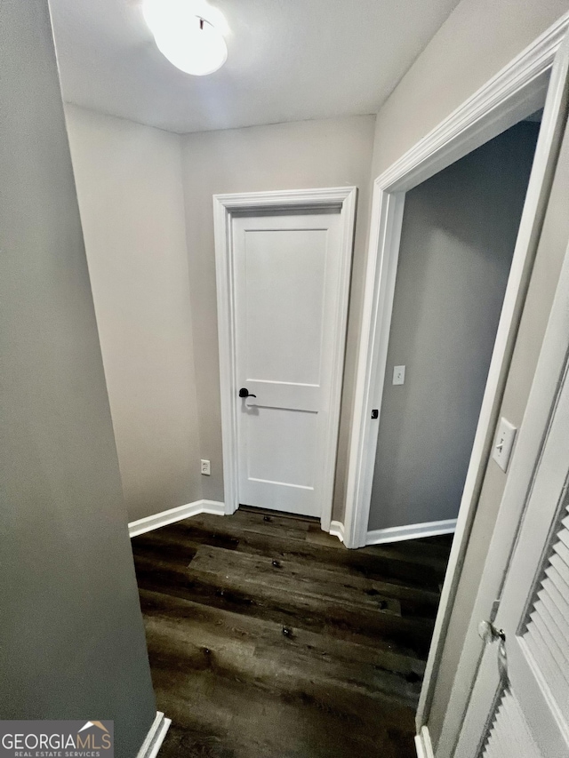 corridor with dark wood-type flooring