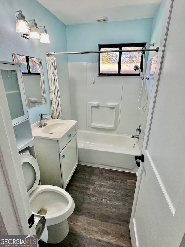 full bathroom with hardwood / wood-style floors, vanity, toilet, and shower / bathtub combination with curtain