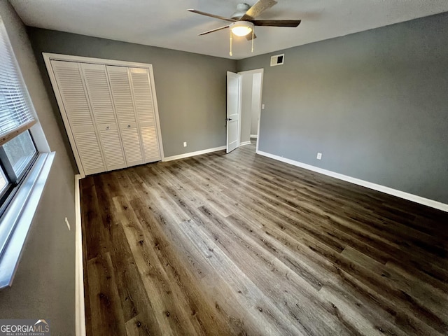 unfurnished bedroom with a closet, ceiling fan, and hardwood / wood-style flooring