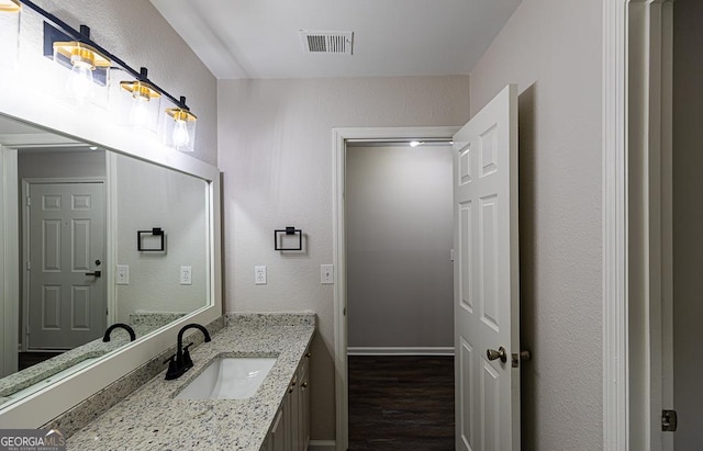 bathroom featuring wood-type flooring and vanity