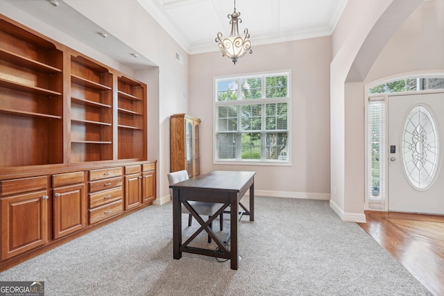 office area featuring arched walkways, crown molding, light wood finished floors, visible vents, and baseboards