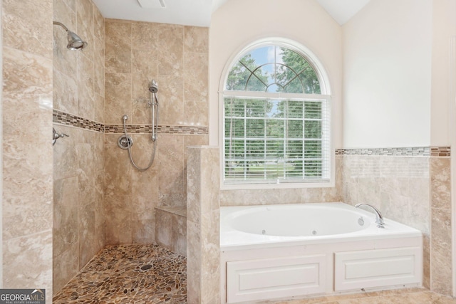 bathroom featuring vaulted ceiling, tiled shower, and a bath