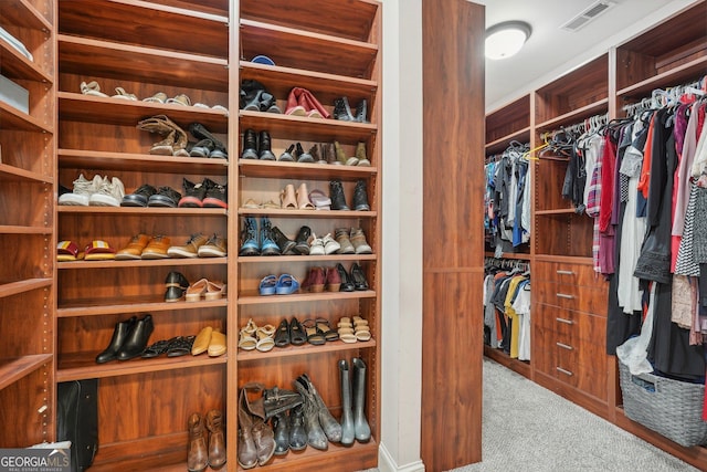 walk in closet with visible vents and carpet flooring