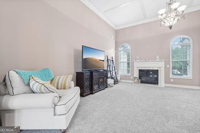 living area featuring crown molding, a notable chandelier, a fireplace with flush hearth, carpet flooring, and baseboards