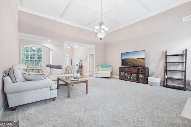 carpeted living area with crown molding, baseboards, arched walkways, and a notable chandelier