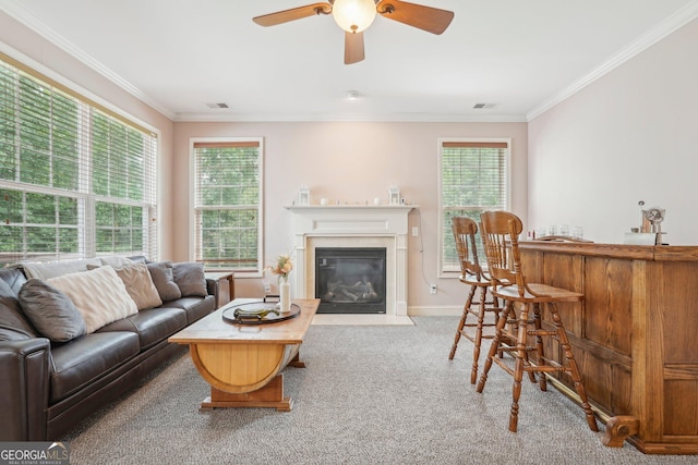 carpeted living room featuring ornamental molding, visible vents, and a healthy amount of sunlight