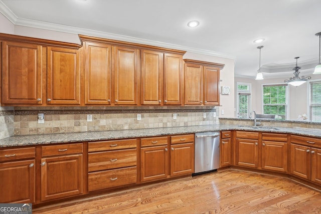 kitchen featuring a sink, crown molding, brown cabinetry, and dishwasher