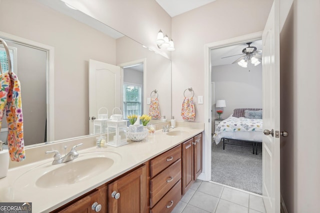 full bathroom with ceiling fan, double vanity, a sink, and tile patterned floors