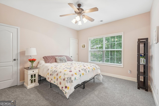 bedroom with carpet, visible vents, baseboards, and a ceiling fan