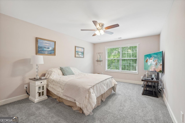 bedroom featuring light colored carpet, ceiling fan, visible vents, and baseboards