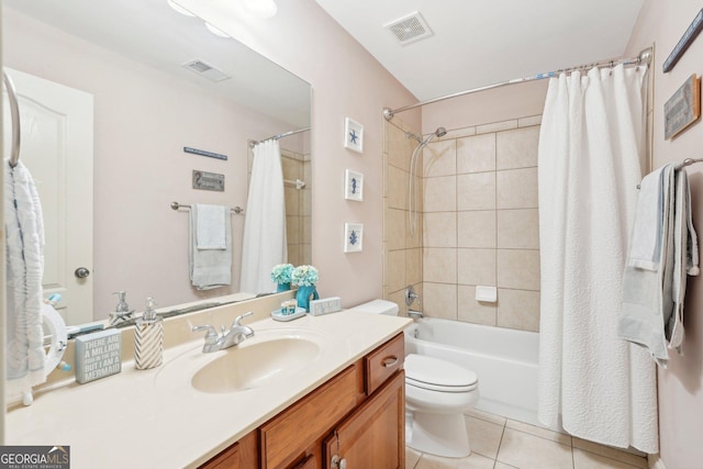 full bath featuring toilet, vanity, visible vents, and tile patterned floors