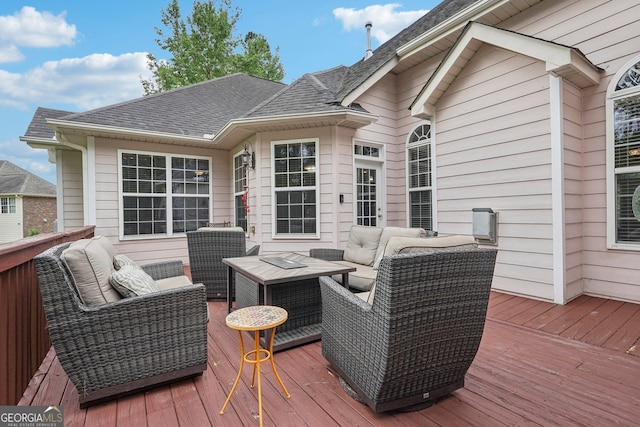 wooden terrace with an outdoor hangout area