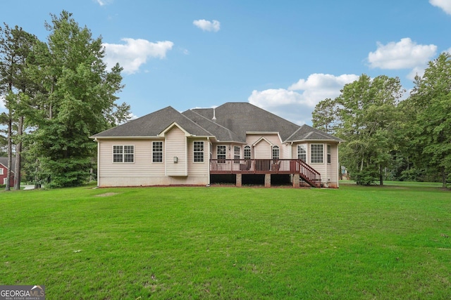 rear view of property with a yard and a deck