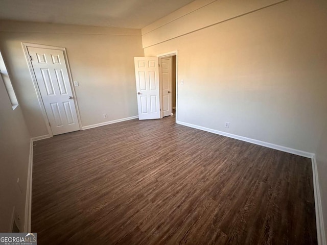 unfurnished bedroom with dark hardwood / wood-style floors