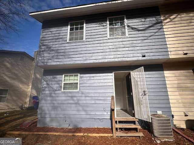 rear view of house featuring central AC unit