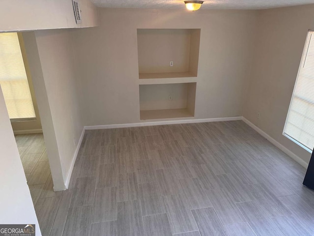 spare room with a textured ceiling