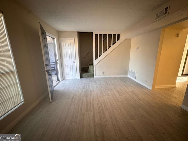 empty room with hardwood / wood-style floors